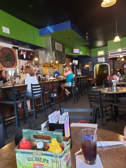 The original Andy's Place bar with green walls and a long wooden bar